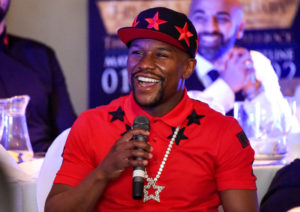 Floyd Mayweather Jr. is interviewed in front of fans at a small club in Cannock
